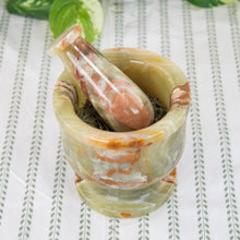 Load image into Gallery viewer, Green &amp; White 5" Mortar &amp; Pestle top down with herbs inside on a style background - Down To Earth
