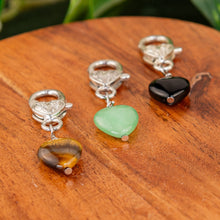 Load image into Gallery viewer, Crystal Heart Pet Pendants group photo on a wooden surface low angle - Down to Earth

