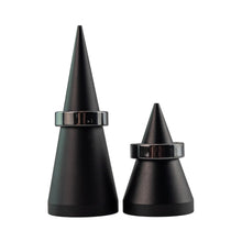 Load image into Gallery viewer, "Two black conical objects with metallic bands on a white background," - Down to Earth.
