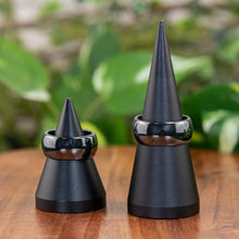 Load image into Gallery viewer, Thick Hematite Ring displayed on a ring stand on a wooden surface - Down to Earth
