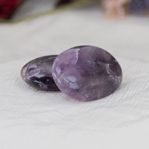 Amethyst Palm Stones  on a white cloth - Down to Earth 
