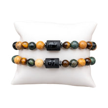 Load image into Gallery viewer, "Two Leo Zodiac Bracelets on a white pillow," - Down to Earth.

