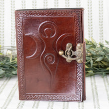 Load image into Gallery viewer, Moon Goddess Leather Journal front facing with plants on a style background - Down To Earth
