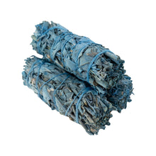 Load image into Gallery viewer, "Three bundles of Nag Champa White Sage smudge sticks stacked on top of one another on a white background," - Down to Earth.
