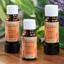 Load image into Gallery viewer, Nature’s Alchemy Essential Oil on a wooden surface second angle - Down to Earth
