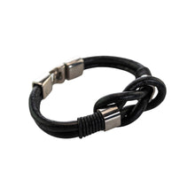 Load image into Gallery viewer, "Black braided leather bracelet with silver metal clasp on a white background," - Down to Earth.
