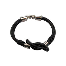 Load image into Gallery viewer, "Black braided cord bracelet with silver clasp on a white background," - Down to Earth.
