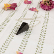 Nuummite Faceted Pendulum on a style background - Down To Earth