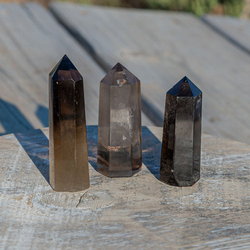 Smokey Quartz group photo on a wooden surface - Down to Earth 