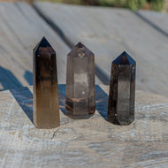 Smokey Quartz group photo on a wooden surface - Down to Earth 