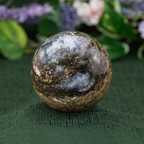 Ocean Jasper Sphere on a green background - Down to Earth 