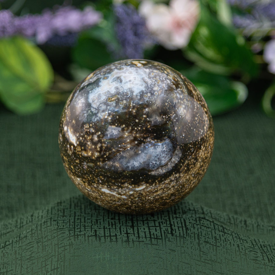 Ocean Jasper Sphere on a green background - Down to Earth 