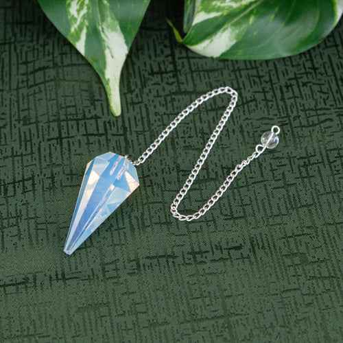 Opalite Pendulum on a green background - Down to Earth