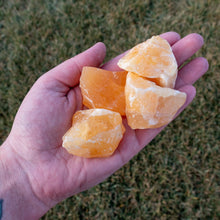 Load image into Gallery viewer, Raw Orange Calcite in Palm of Hand - Down to Earth
