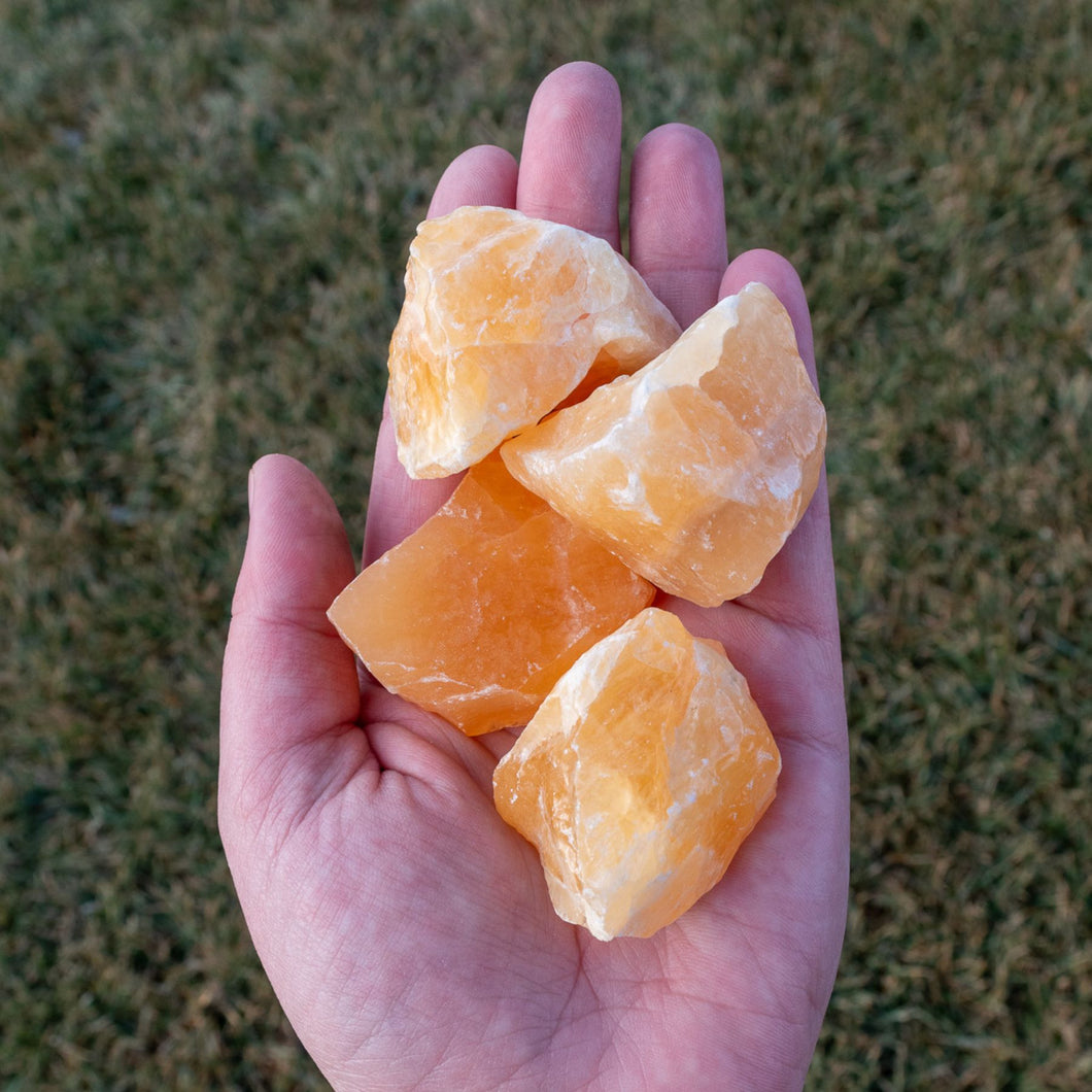 Raw Orange Calcite in Palm of Hand - Down to Earth