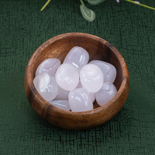 Pink Calcite in a wooden bowl on a green cloth - Down to Earth 