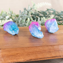 Load image into Gallery viewer, Pink &amp; Blue Aura Quartz Points side facing on a style background - Down To Earth
