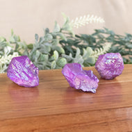 Purple Aura Quartz Point side facing on a style background - Down To Earth