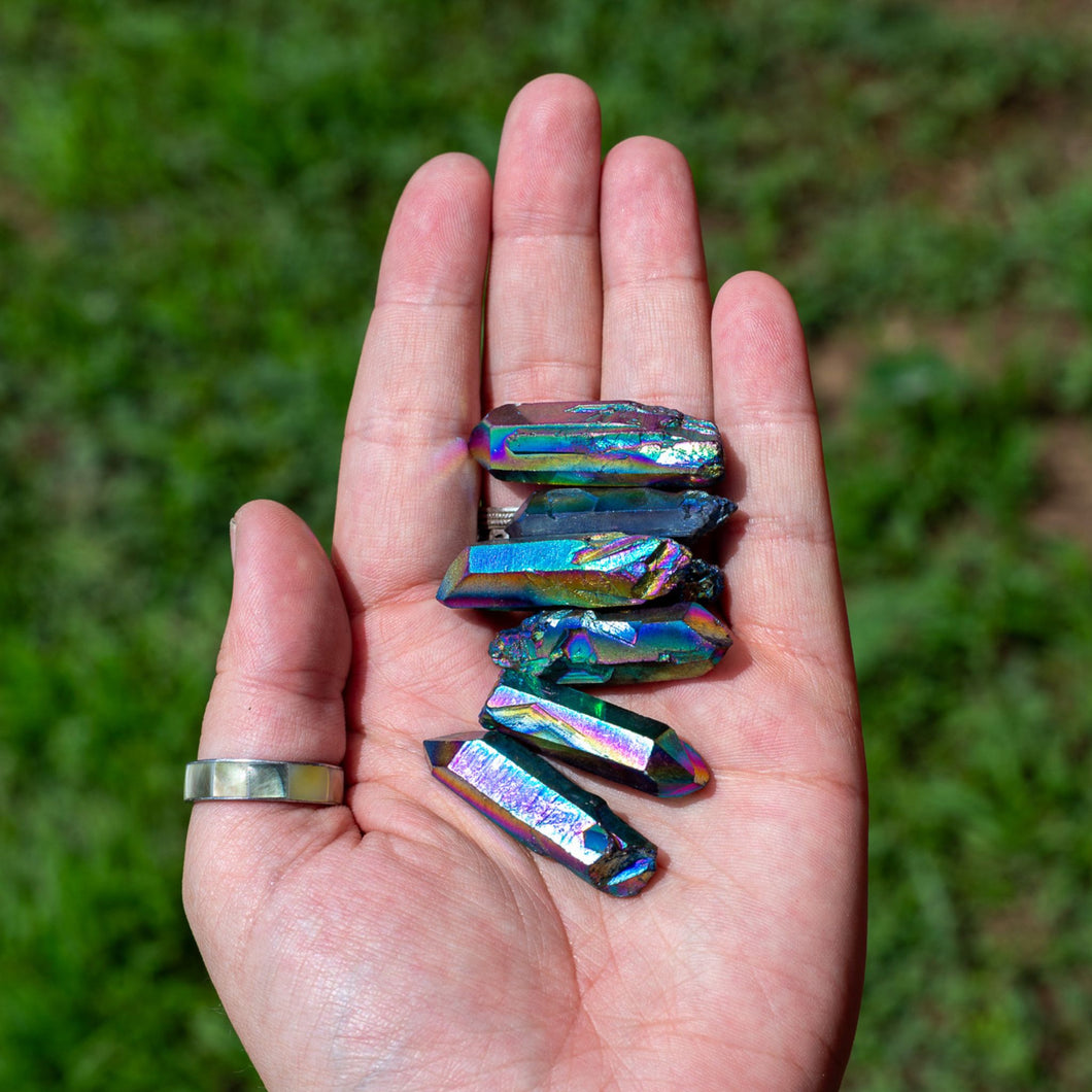 Rainbow Aura Quartz Points in the Palm of  a Hand - Down To Earth