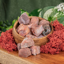 Load image into Gallery viewer, Carnelian Raw crystals displayed on a colorful background - Down to Earth
