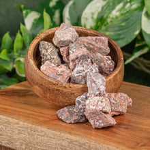 Load image into Gallery viewer, Leopardskin Jasper Raw displayed on a wooden surface overfilling from a wooden bowl - Down to Earth
