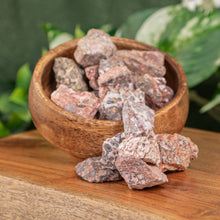 Load image into Gallery viewer, Leopardskin Jasper Raw displayed on a wooden surface overfilling from a wooden bowl second angle - Down to Earth
