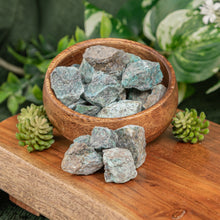 Load image into Gallery viewer, Turquoise Raw displayed on a colorful background in a wooden bowl - Down to Earth
