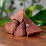 Red Jasper Raw on a wooden surface - Down to Earth