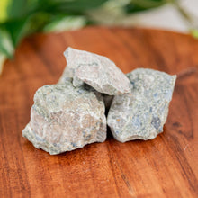 Load image into Gallery viewer, Rhyolite Raw on a wooden surface high angle - Down to Earth
