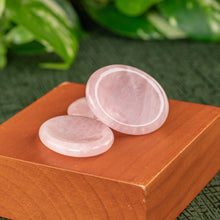 Load image into Gallery viewer, Rose Quartz Calming Stone displayed on a wooden surface with greenery in the background side angle - Down to Earth 
