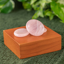 Load image into Gallery viewer, Rose Quartz Calming Stone displayed on a wooden surface with greenery in the background - Down to Earth 
