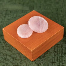 Load image into Gallery viewer, Rose Quartz Calming Stone displayed on a wooden surface with greenery in the background top down angle - Down to Earth 
