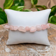 Rose Quartz Tumbled Stone Bracelet on White Pillow Styled Photo - Down To Earth