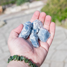 Load image into Gallery viewer, Blue Calcite Raw in hand outdoor styled photo - Down to Earth
