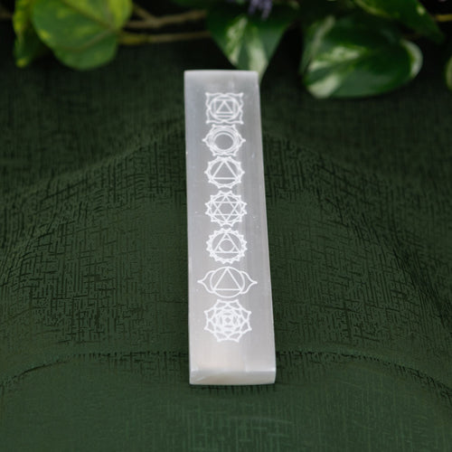 Selenite engraved Chakra Ruler on a green background - Down to Earth 