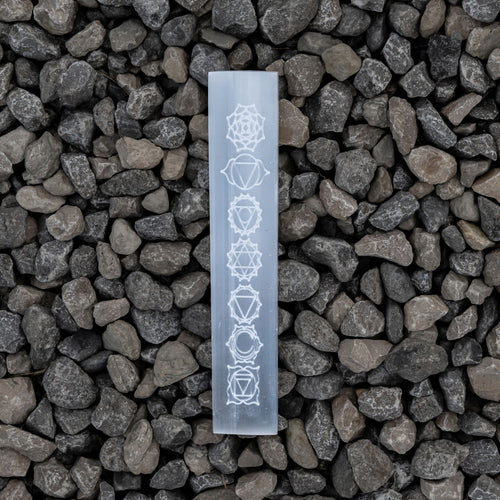 Selenite engraved Chakra Ruler on a rock background - Down to Earth 