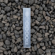 Selenite engraved Chakra Ruler on a rock background - Down to Earth 