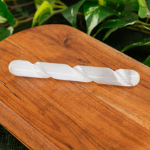 Load image into Gallery viewer, Selenite Spiral Massage Wand on a wooden surface - Down to Earth
