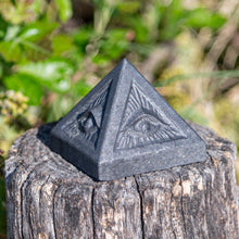 Load image into Gallery viewer, Shungite Evil Eye Pyramid outdoors picture - Down to Earth
