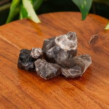 Load image into Gallery viewer, Smoky Chevron Amethyst Raw on a wooden surface - Down to Earth
