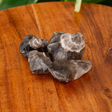 Load image into Gallery viewer, Smoky Chevron Amethyst Raw on a wooden surface high angle - Down to Earth
