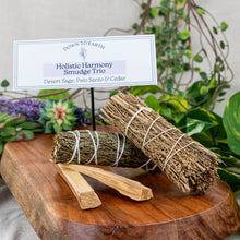 Load image into Gallery viewer, Holistic Harmony: Desert Sage, Palo Santo &amp; Cedar on a wooden surface low angle - Down to Earth
