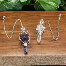 Load image into Gallery viewer, Spinning Merkaba Pendulum up close with plants displayed on a styled background - Down To Earth
