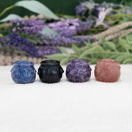 HoneyPot Statues including Sodalite, Black Obsidian, Amethyst, and Strawberry Quartz on a white surface with a blurred natural background - Down to Earth