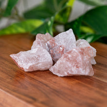 Load image into Gallery viewer, Strawberry Calcite Raw Pakistan on a wooden surface - Down to Earth 
