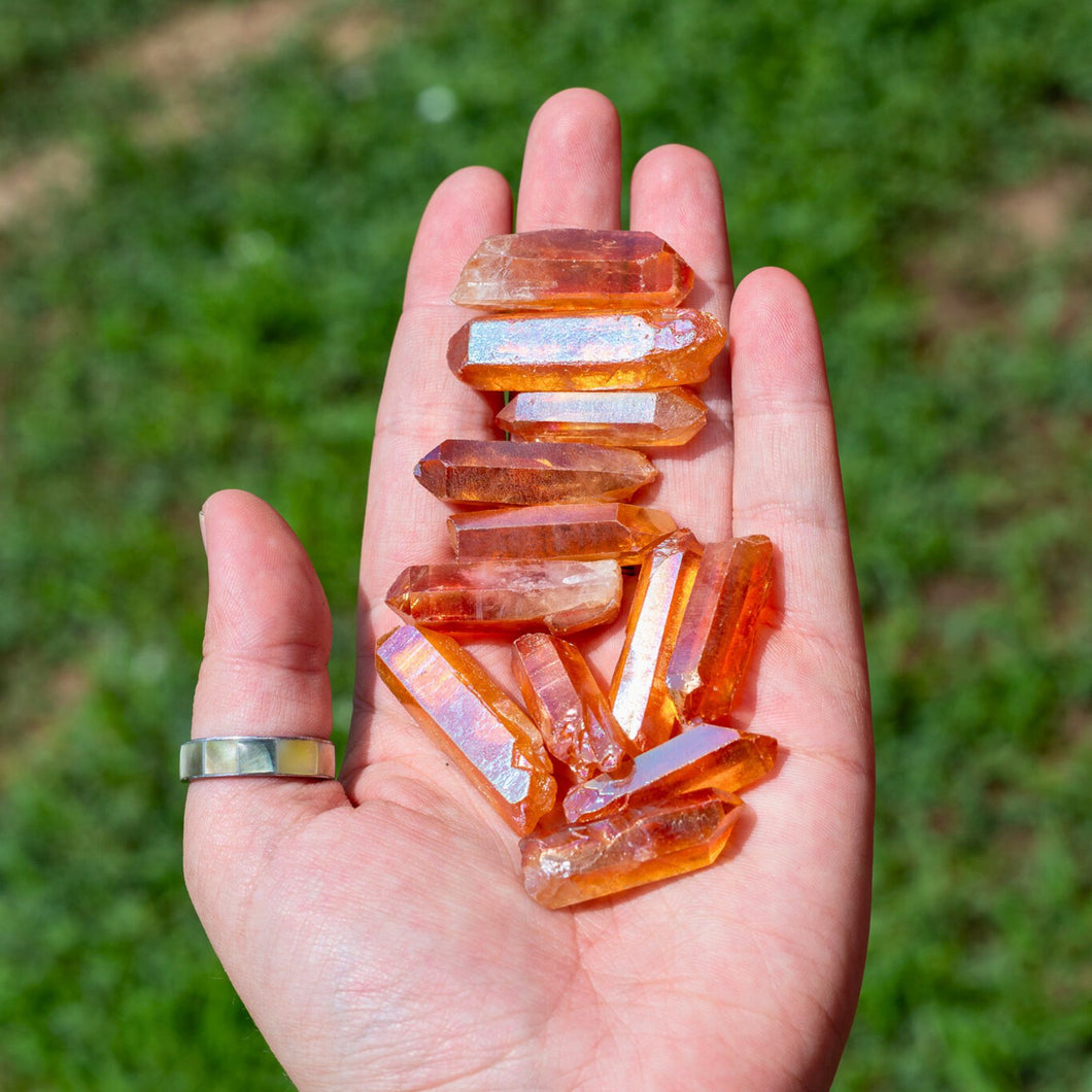 Tangerine Aura Quartz Points in the Palm of a Hand - Down To Earth