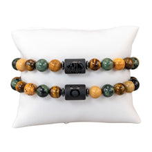 Load image into Gallery viewer, "Two Taurus Zodiac Bracelets that showcase the astrological symbol as well as the animal that represents the sign on a white background," - Down to Earth.

