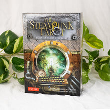 Load image into Gallery viewer, The Steam Punk Tarot front facing with plants on a style background - Down To Earth

