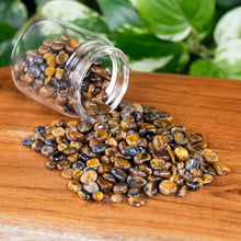 Load image into Gallery viewer, Tiger's Eye Crystal Chips 1lb up close with jar displayed on a styled background - Down To Earth
