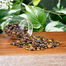 Load image into Gallery viewer, Tiger's Eye Crystal Chips 1lb front facing with jar displayed on a styled background - Down To Earth

